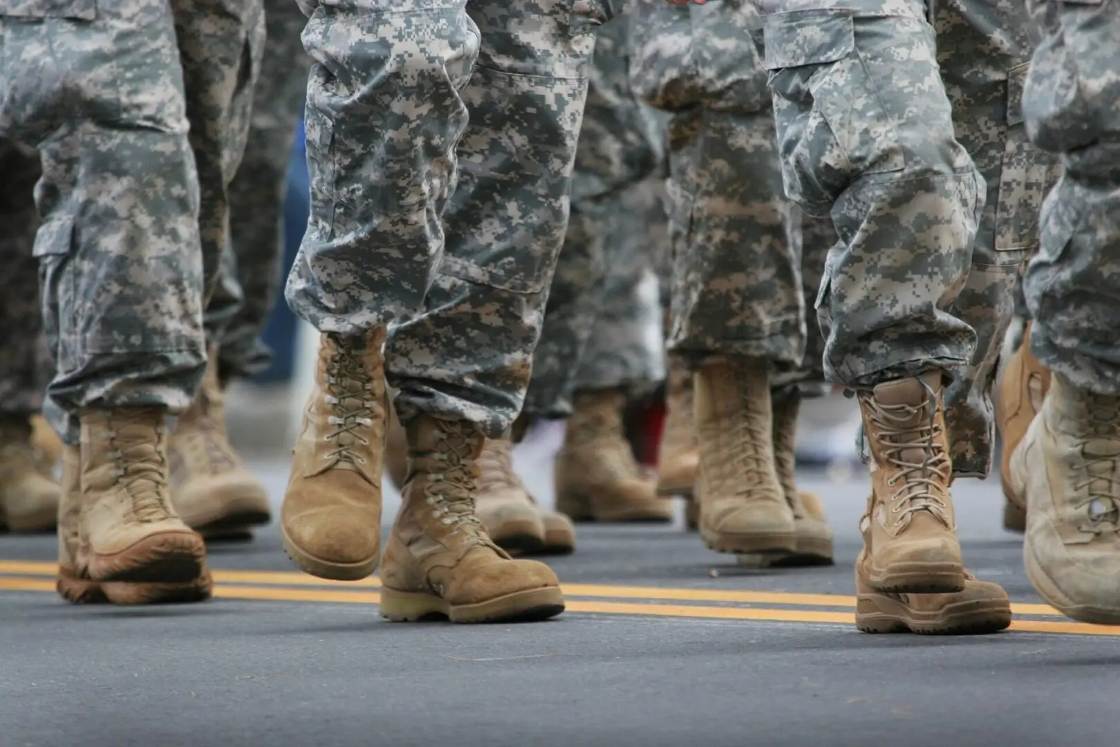 A close up of soldiers in fatigues and boots